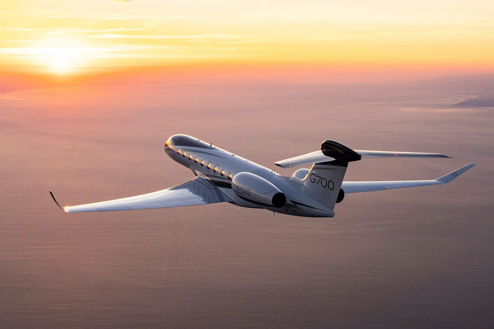 Gulfstream business jet flying at sunset