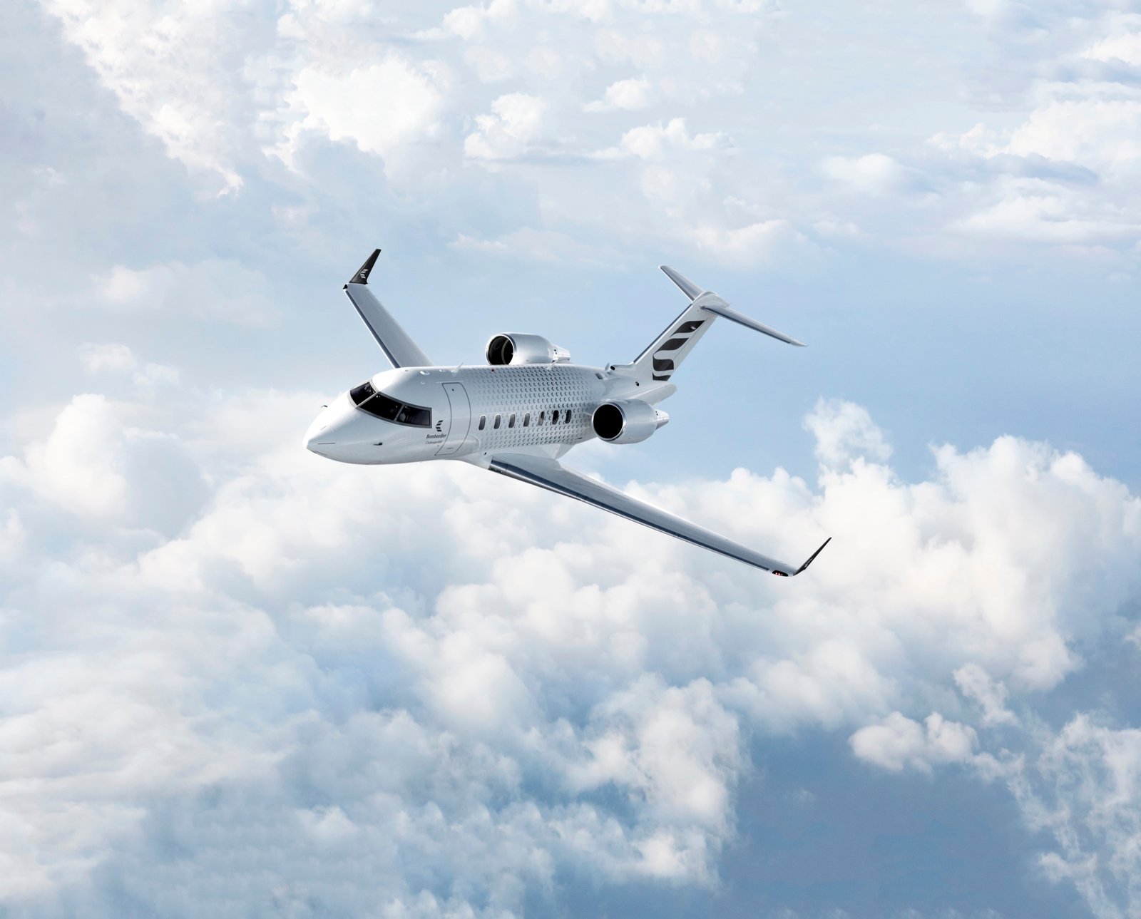 Bombardier Challenger 650 flying above clouds